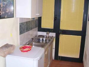 a small kitchen with a sink and a stove at Le Camporelle In Campagna in Cavallino di Lecce