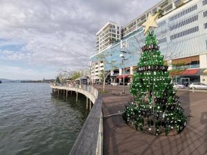 a christmas tree on a pier next to the water at 5 Bedrooms Penthouse 3 Bedrooms Apartment Marina Court Resort Condominium in Kota Kinabalu