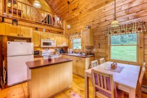 a kitchen with wooden cabinets and a white refrigerator at Log Cabin Escape in Jacksonville