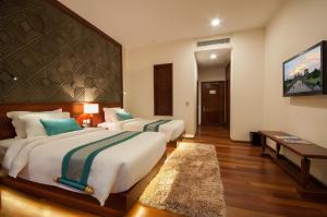 Voodi või voodid majutusasutuse Lotus Blanc Resort toas