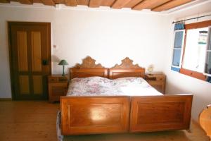 a bedroom with a wooden bed in a room at Apartments Steffler in Grundlsee