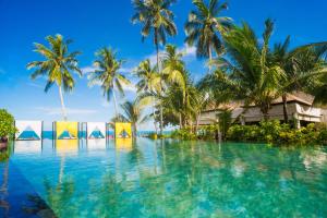 a pool in front of a resort with palm trees at Weekender Resort in Lamai