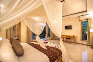 Säng eller sängar i ett rum på Puri Sedana Ubud Villa