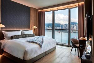 a bedroom with a large bed and a large window at K11 ARTUS in Hong Kong