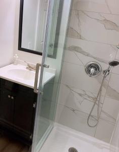 a bathroom with a shower and a sink at Nice rooms with private bath in Mid Town Toronto in Toronto