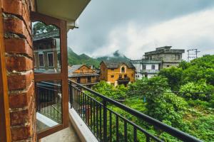 a balcony with a view of a city at Shristi Hotel & Lodge in Bandipur