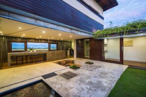 a modern house with a garden in the yard at Ocean Villa - Joshua District in Tabanan