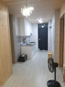 an empty kitchen with a black door in a room at Grace River House Block A - Couple Room in Hoengsong