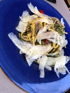 a blue plate of food with onions on it at Hotel Concordia in Porlezza