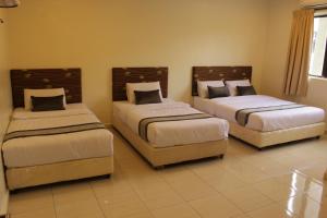 Säng eller sängar i ett rum på Hotel Bandar Baru Menglembu