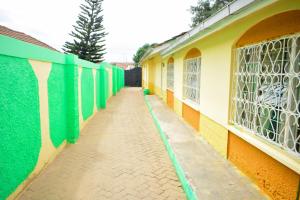 an empty alley with green and yellow walls at Kenya Inn in Nairobi