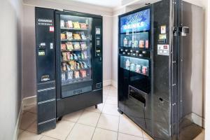 two soda machines are next to each other at Studio 6-Fort Worth, TX - West Medical Center in White Settlement