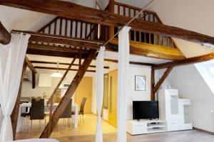 a loft conversion with a living room and dining room at Ferienwohnungen Zierzow in Sietow
