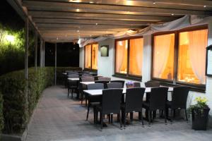 a row of tables and chairs in a restaurant at Pension Kellerer in Raubling