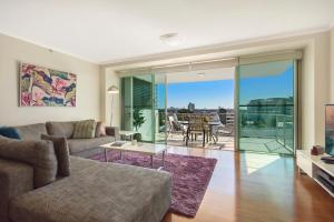 a living room with a couch and a table at m1 Resort in Maroochydore