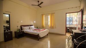 a bedroom with a bed and a window at Woodside residency in Thekkady +68 photos