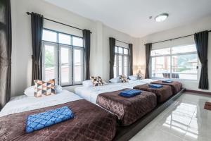 three beds in a room with large windows at Sea Horse Pool villa Ao nang in Ao Nang Beach +48 photos