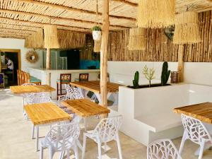 a restaurant with wooden tables and chairs at So KohKoon Beach Resort in Bang Rak Beach