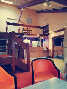 a room with two orange chairs and a table at Hotel Bonanite in Villers-Cotterêts