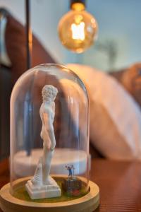 a glass dome with a figurine on a table at The Blender Loft in Melbourne