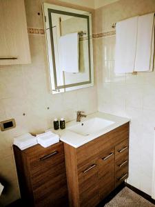 a bathroom with a sink and a mirror at CASA MATTEOTTI Mezzana Trentino in Mezzana