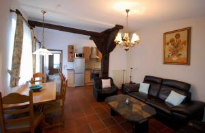 a living room with a couch and a table at Ferienwohnungen Wulfshof II in Schneverdingen