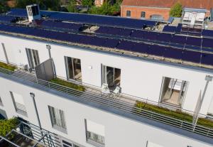 an overhead view of a white building with blue roofs at first Apart in Erlangen