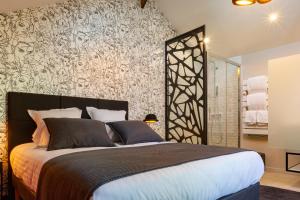 ein Schlafzimmer mit einem großen Bett und einem Wandbild in der Unterkunft La Ressourçante in Puisieulx