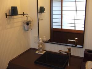 a bathroom with a sink and a window at Shinseikan in Nishiwaga