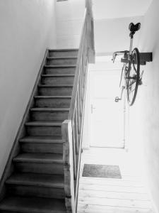 uma bicicleta pendurada numa parede ao lado de uma escada em Studio Flandrien em Oudenaarde
