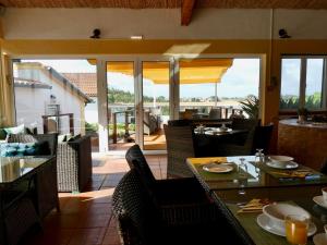 a restaurant with a table and chairs and a patio at Vida-Vi, Country House and B&B in Santa Catarina