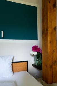 a bedroom with a bed and a vase of flowers at historic Apart in Erlangen