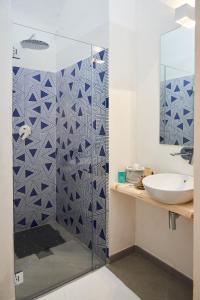 a bathroom with a blue and white patterned shower at Style Home in Salerno