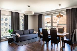 a living room with a dining room table and a couch at Apartament Chmielna in Gdańsk