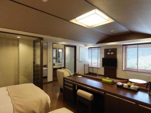 a hotel room with a bed and a desk at Jozankei Tsuruga Resort Spa Mori no Uta in Jozankei