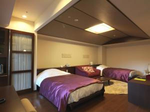 a bedroom with a bed and a desk at Jozankei Tsuruga Resort Spa Mori no Uta in Jozankei