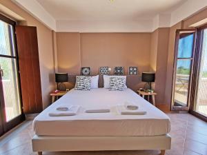 a large bed in a room with two tables at Anaroussa Diros Maisonette in Areopoli