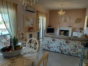 a living room with a couch and a fireplace at Flowerhouse in Porto Heli