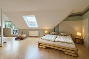 a bedroom with a large bed in a attic at Ferienwohnungen "Am Waidweg" in Bad Langensalza