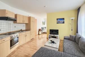a kitchen and living room with a couch and a table at Ferienwohnungen "Am Waidweg" in Bad Langensalza