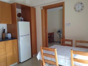 a kitchen with a white refrigerator in a room at St. Lazaros Seaside Apartment in Larnaca