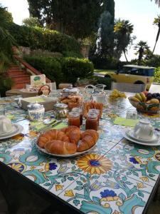a table with croissants and other food on it at Resort Villa San Luca CITR8031 in Imperia