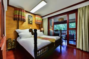 Postel nebo postele na pokoji v ubytování Xishuangbanna Elephant Home Guesthouse