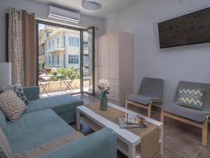 a living room with a couch and a table at Heraklions Heart Apartment in Heraklio