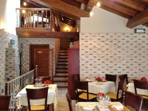 a restaurant with tables and chairs and a staircase at Hostal Cerezo 2 in Guadalupe