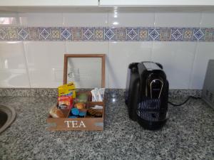 a telephone sitting on a counter next to a box of food at Casa Angel in Cáceres