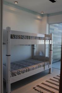 a bedroom with two bunk beds in a room at liberty 305 in Cabo Frio