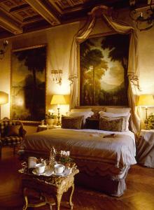 a bedroom with a large bed with a painting on the wall at Residenza Napoleone III in Rome