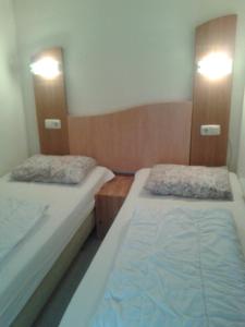 twee bedden in een kleine kamer met bij Bij De Vuurtoren in Hollum