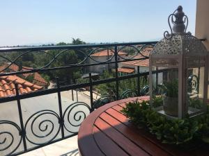 a table on a balcony with a view of a house at Athena's Luxury Place in Agria